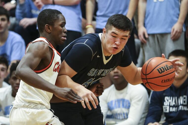 Shawnee's Dylan Deveney drives on Cherokee's Olarewajo Oladipo in a December game.