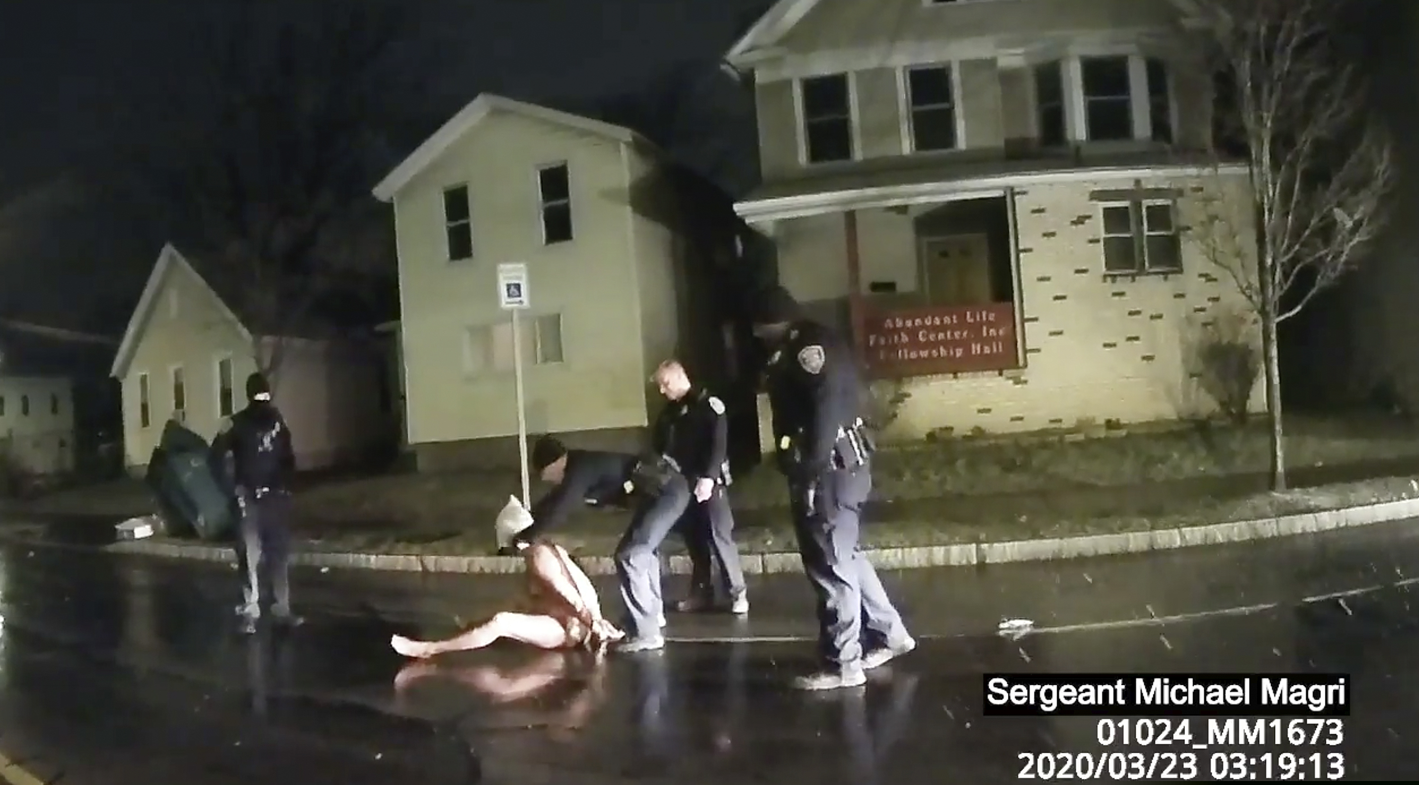 In this image taken from police body camera video provided by Roth and Roth LLP, a Rochester police officer puts a hood over the head of Daniel Prude, on March 23.