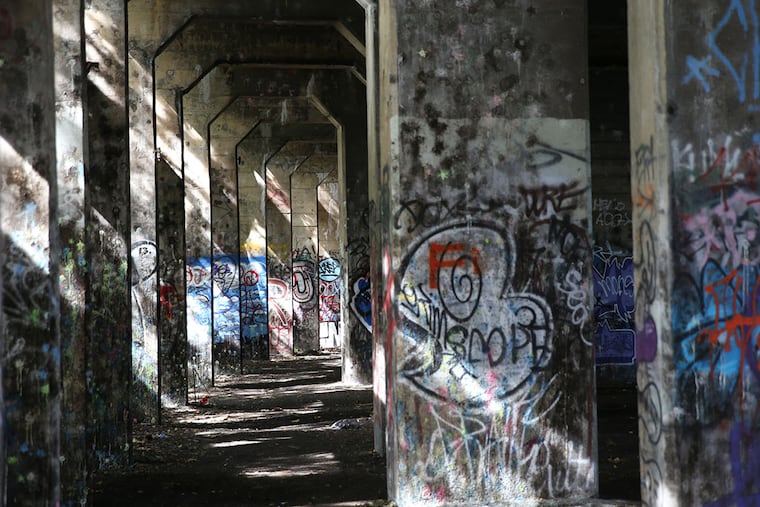 Graffiti covers a pier on the Delaware River near Cumberland Street in Philadelphia on September 23, 2014.