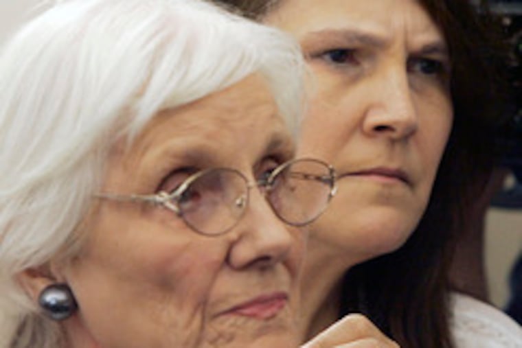 Barbara Wells White, the sister of slain pizza deliveryman Brian Wells, holds her mother, Rose Marie Wells, after a news conference.