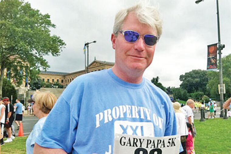 John J. Dougherty, business manager of IBEW Local 98, holds his racing number Sunday at the 10th annual Gary Papa Father's Day Run. (Stephanie Farr / Staff)
