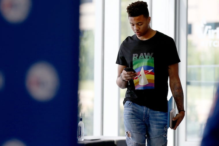 Markelle Fultz checks his phone before he talks to reporters at the Sixers' practice facility in Camden.