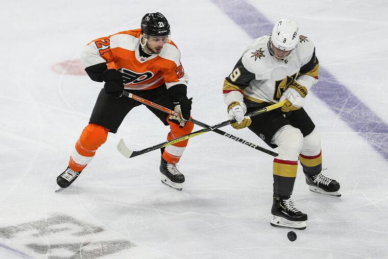 Flyers Scott Laughton and Golden Knights Jack Eichel try for the puck during the second period at the Wells Fargo Center in Philadelphia, Tuesday, March 8, 2022.
