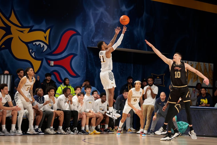 Justin Moore (left) of Drexel hits the game-winning shot on Thursday against College of Charleston.