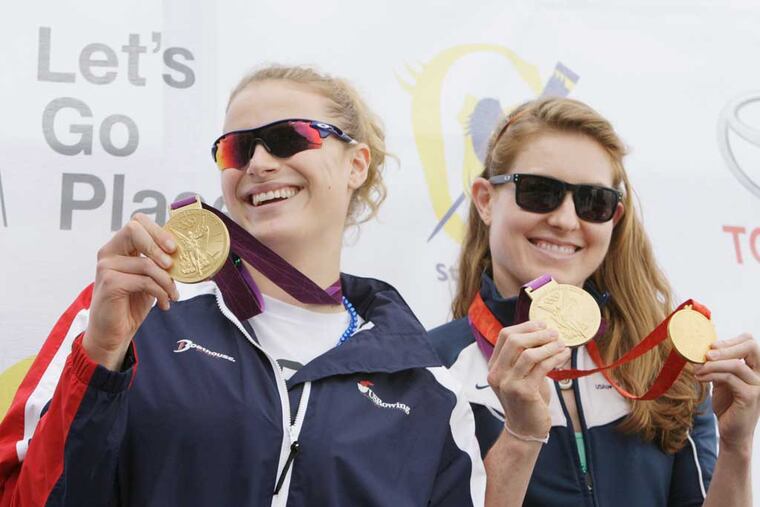 Olympic champion rowers Taylor Ritzel (left) and Caroline Lind show off their gold medals after speaking briefly at the 2013 Stotesbury Cup Regatta. ( ELIZABETH ROBERTSON / Staff Photographer )