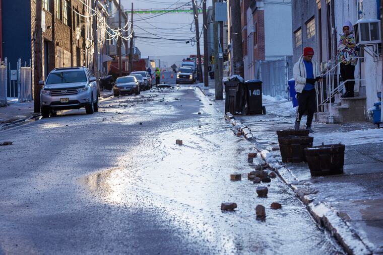 Water Flowing down W. Penn from a main break at corner of W. Penn and Cherry that sent water running down W. Penn Street on a freezing Monday morning in Norristown, PA, Jan. 22, 2024.
