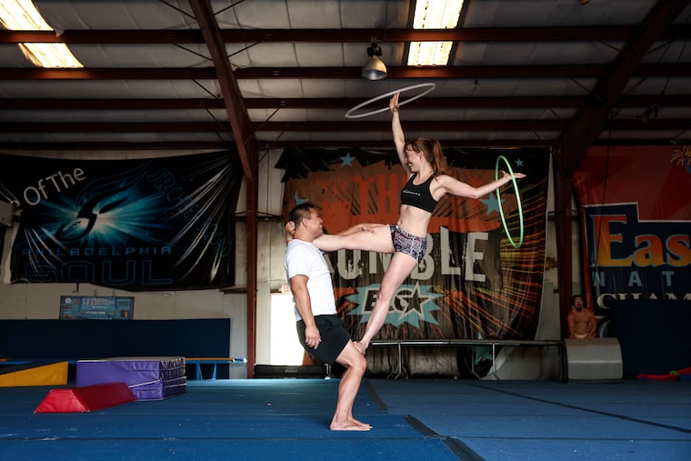 Rob Li and Acacia Noel work on a flag with hoops during a Philly Acro Skill Share on July 5 at Power Athletics.