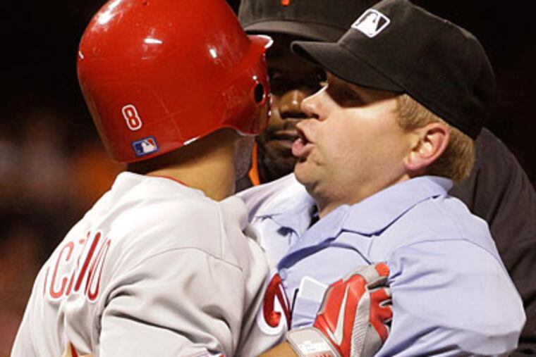 Shane Victorino tried to push umpire Mike Muchlinski out of his way several times during Friday's fight. (Ben Margot/AP)