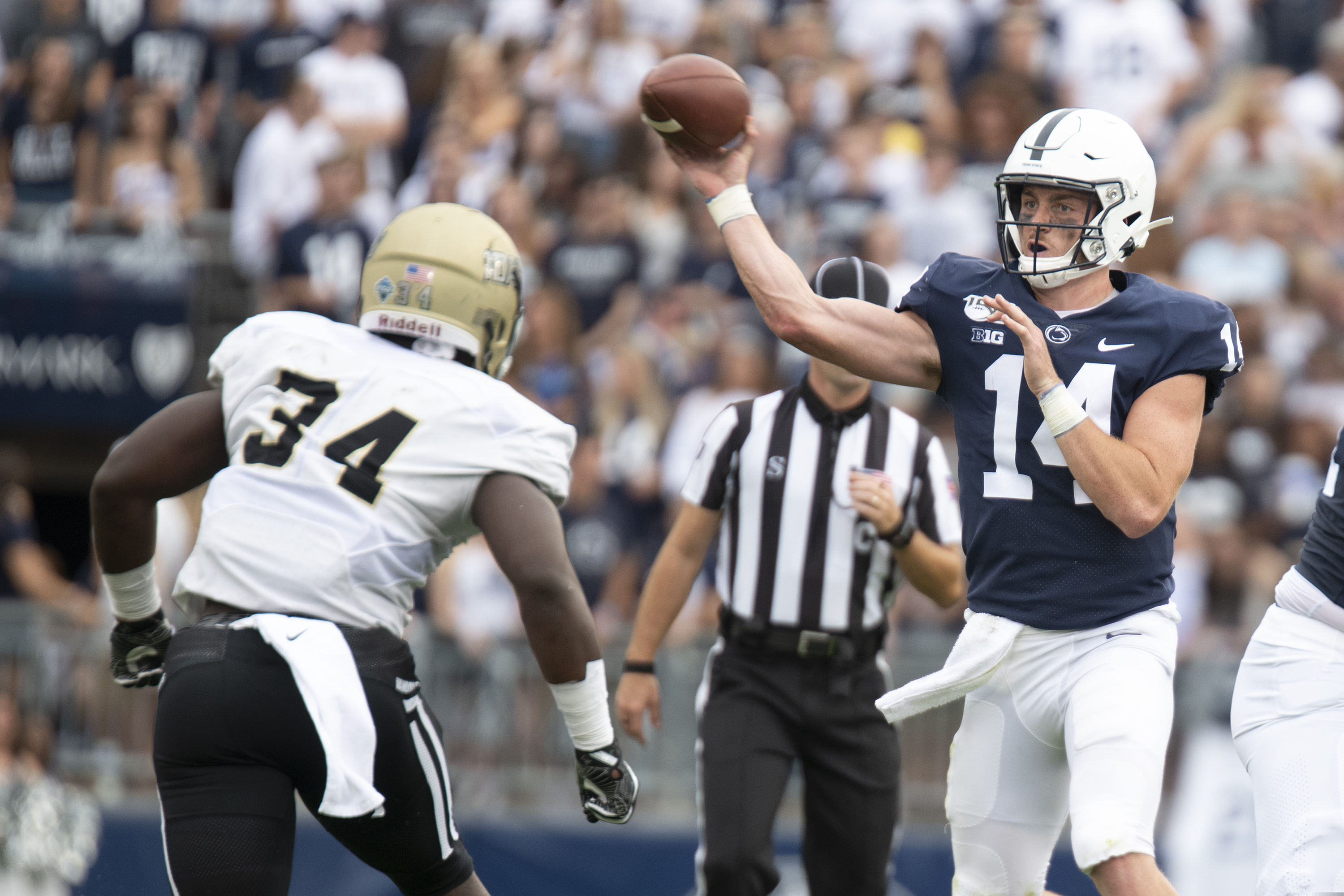 Penn State quarterback Sean Clifford (14) passes over Idaho linebacker Leo Tamba on Aug. 31.