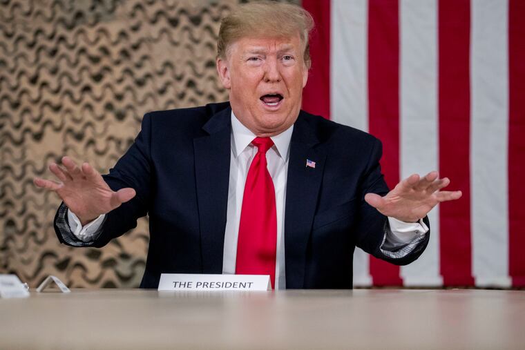 President Donald Trump speaks to members of the media at Al Asad Air Base, Iraq, Wednesday, Dec. 26, 2018.