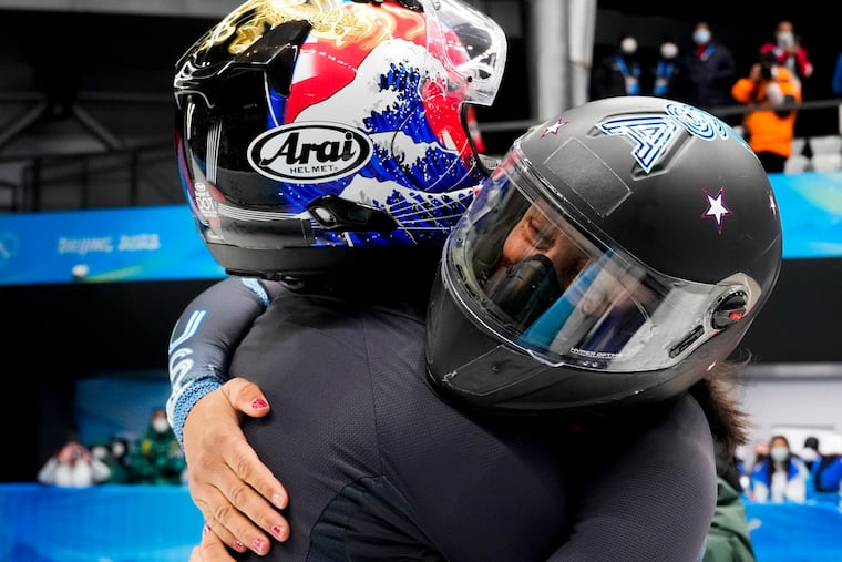 Elana Meyers Taylor and Sylvia Hoffman, of the United States, celebrate after the women's bobsleigh heat 4 at the 2022 Winter Olympics, Saturday, Feb. 19, 2022, in the Yanqing district of Beijing.