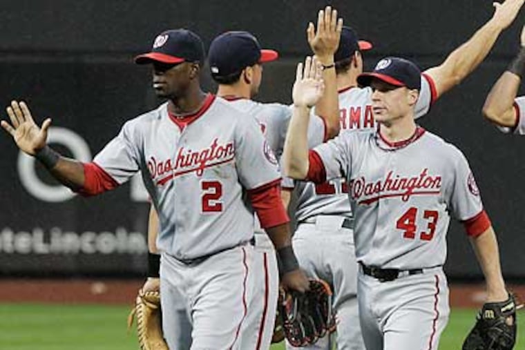 The Nationals' Roger Bernadina (2) and Brian Bixler (43) celebrate their win over the Mets on Thursday. (Frank Franklin II/AP)
