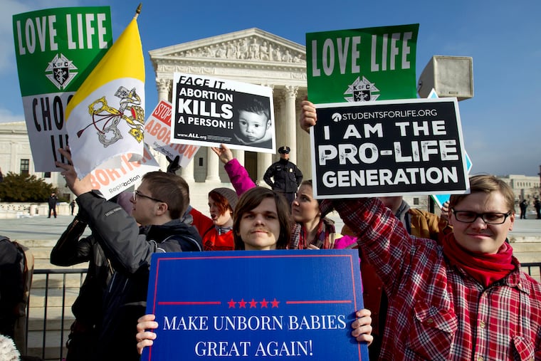 FILE - In this Jan. 18, 2019, file photo, anti-abortion activists protest outside of the U.S. Supreme Court, during the March for Life in Washington. The number and rate of abortions across the United States have plunged to their lowest levels since the procedure became legal nationwide in 1973, according to new figures released Wednesday, Sept. 18. (AP Photo/Jose Luis Magana, File)