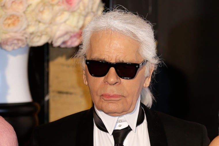 In this Saturday, March 28, 2015 file photo, Karl Lagerfeld poses for photographers as he arrives at the Rose Ball in Monaco.