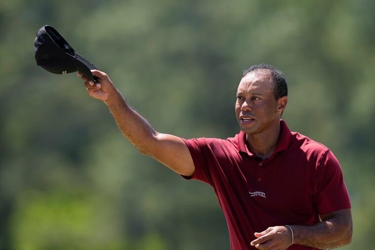 Tiger Woods waves after his final round at the Masters after finishing last among all Sunday qualifiers.