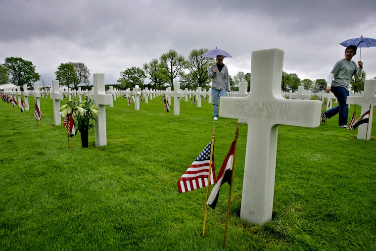 American tourists walk in between the graves of U.S. military World War II victims at the Netherlands American Cemetery in the town of Margraten, southern Netherlands, in May 2005.