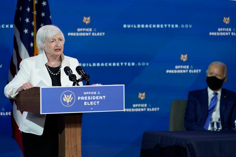 Then-President-elect Joe Biden, right, listens as Janet Yellen, who Biden nominated to serve as Secretary of the Treasury, speaks at The Queen theater in Wilmington. Yellen was confirmed Monday.