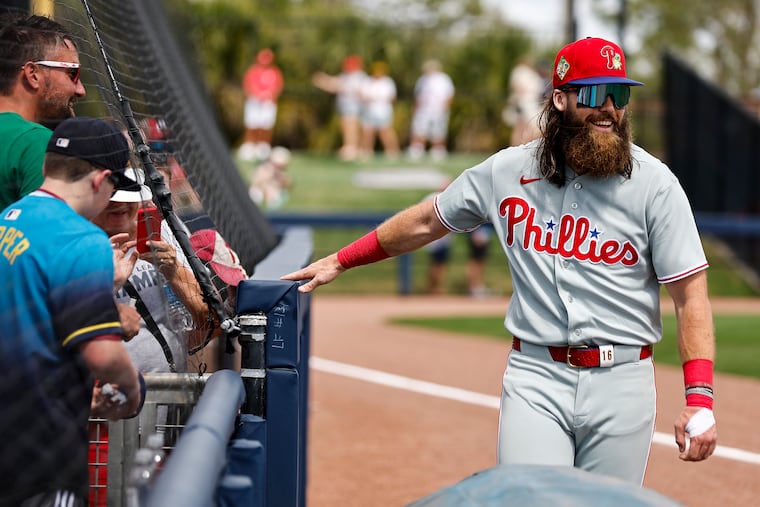 Phillies outfielder Brandon Marsh signs autographs before the game against the Rays on Tuesday in Port Charlotte, Fla.