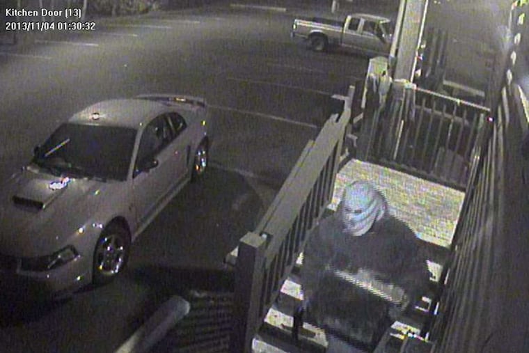 Handout photo from the Whitpain police shows a suspect with a safe after Monday's robbery at the Whitpain Tavern.