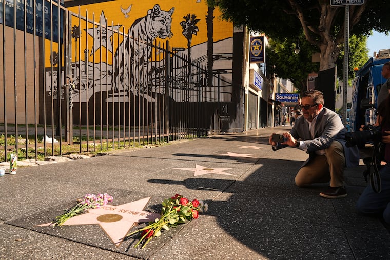 Flowers adorn the Walk of Fame star for Rob Reiner on Monday in Hollywood. President Donald Trump's response to the slaying of Reiner and his wife, Michele Singer Reiner, was less than gracious.