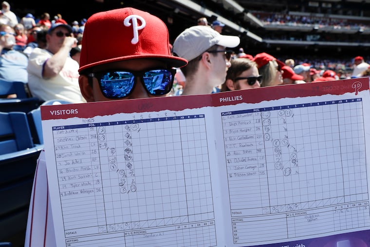 Caleb Leader holds his scorecard while the Phillies played the Los Angeles Angels on June 5, 2022 in Philadelphia.