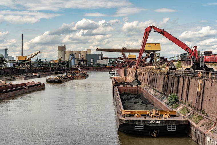 Coal barges being unloaded at an inland harbor in Duisburg, Germany, in 2023.