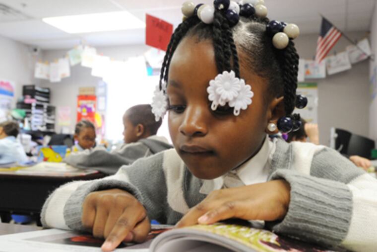 First grader Makayla Barrett works on her reading. Critics challenge the school's academic achievements, especially in light of a state probe of possible state test score cheating. (Clem Murray / Staff Photographer)
