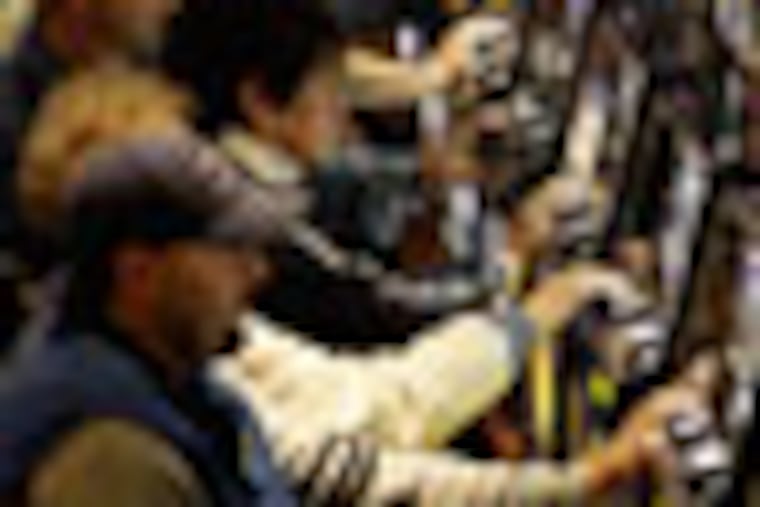 People gamble at the new Mohegan Sun at Pocono Downs casino in Wilkes-Barre, Pa., Tuesday, Nov. 14, 2006. Pennsylvania's first slot-machine parlor opened to the public Tuesday morning more than two years after lawmakers authorized gambling to raise money for property tax relief. (AP Photo/Matt Rourke)