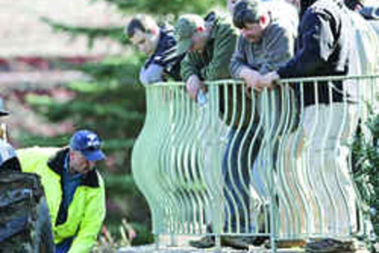 Montgomery County authorities and FBI personnel watch as the Mastronardo yard is dug up in the search for evidence.