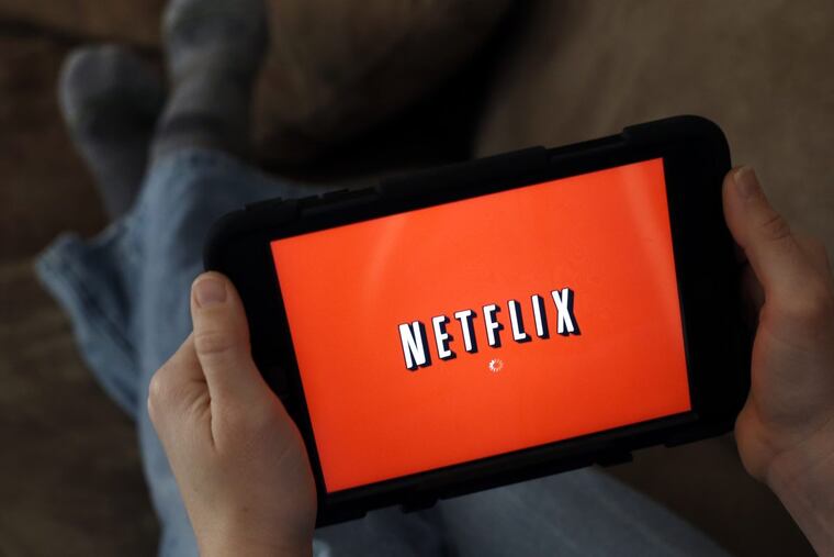 In this Friday, Jan. 17, 2014, file photo, a person displays Netflix on a tablet in North Andover, Mass.