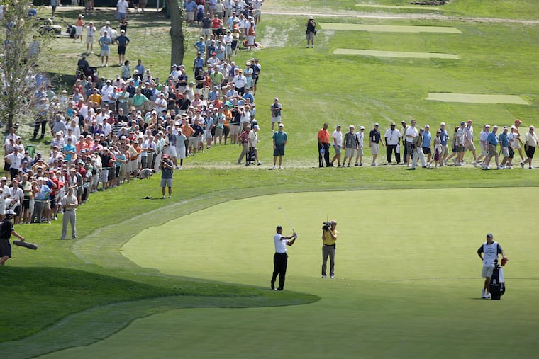 Tiger Woods hits up to the 9th green during the 2010 AT&T National Golf Tournament at Aronimink Golf Club in Newtown Square.