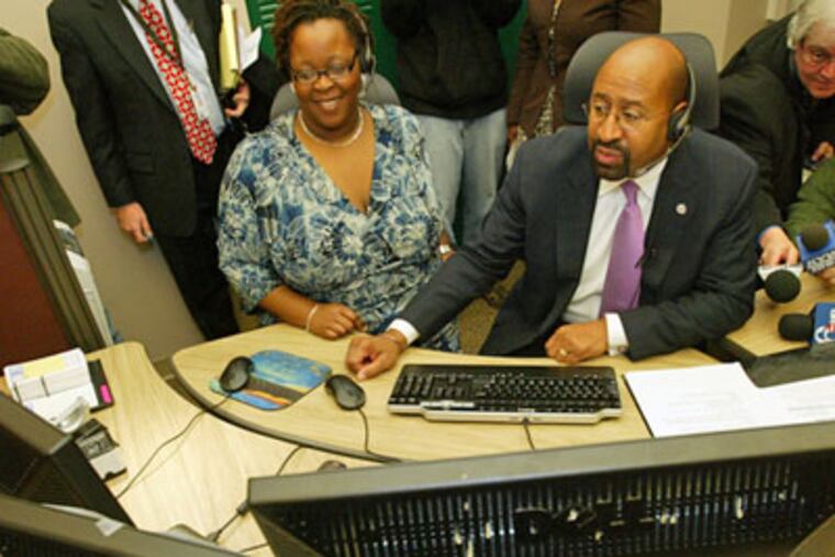 Mayor Nutter answers a 3-1-1 call from a resident as the system opens Wednesday at the call center in City Hall. At left is Robin Aluko, contact center supervisor. (Alejandro A. Alvarez / Staff Photographer)