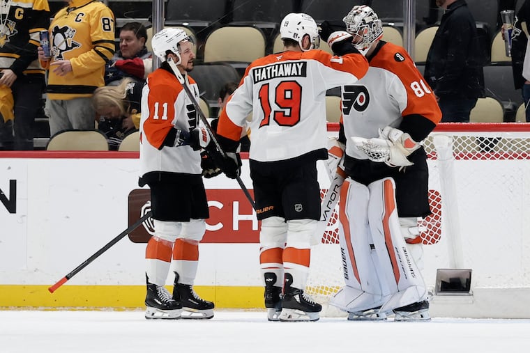 Goaltender Dan Vladař, right wing Garnet Hathaway, and right wing Travis Konecny celebrate after the Flyers took a 2-0 series lead on Monday night.