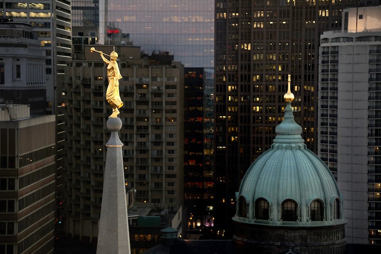 The angel Moroni atop the under-construction Mormon temple joins the cross on the Cathedral Basilica of Ss. Peter and Paul on Logan Circle on Jan. 19, 2016.
