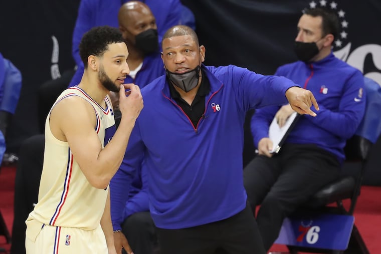 Ben Simmons and xoach Doc Rivers talking on the sideline during an April game.