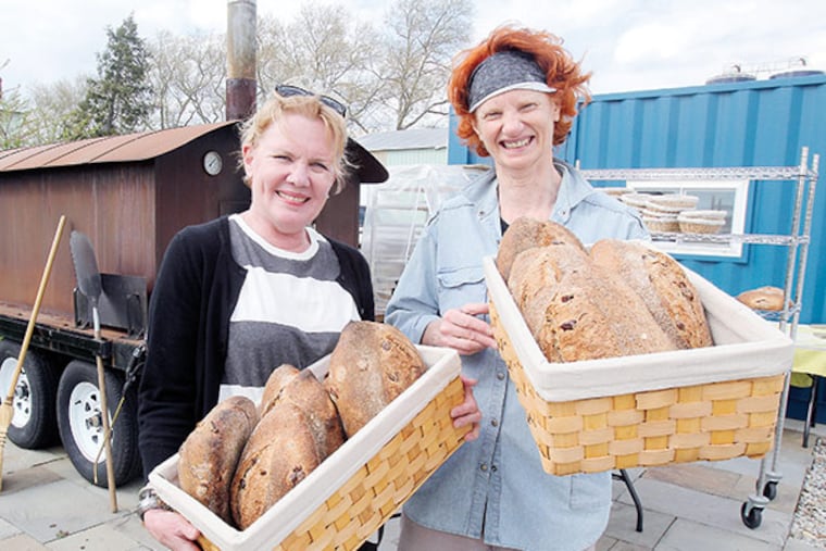 Cindy Quinton (left) and bread baker Donna Wallstin hold just-baked breads in the baskets. ( AKIRA SUWA / Staff Photographer )