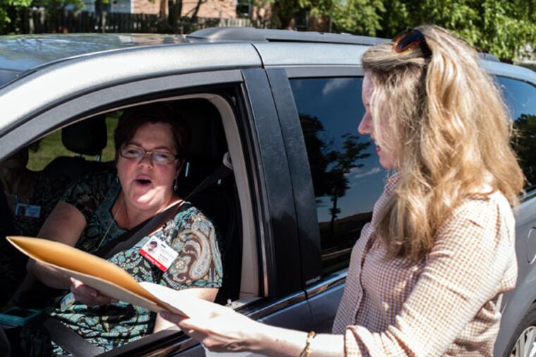 Nurse Heather Jones-DiRosa (left) takes a letter from union organizer Meghan Lane. The letter was to Eagleville Hospital on behalf of its nurses, who voted Thursday to form a union. New rules quickened the process. (MATTHEW HALL/For The Inquirer)