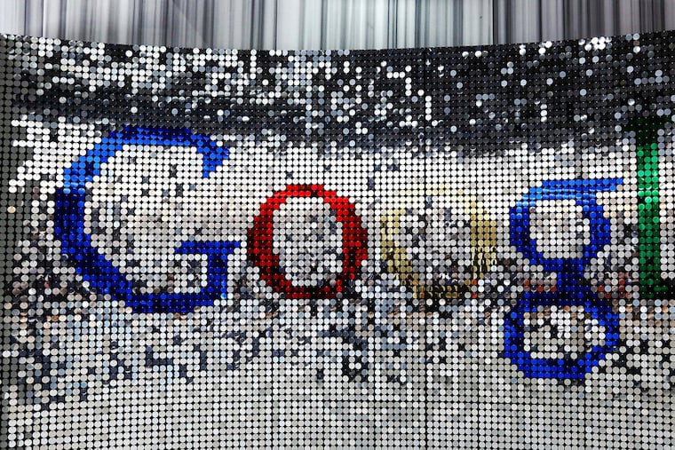 A sign featuring Google Inc.'s logo stands inside the entrance to their U.K. headquarters at Six St Pancras Square in London.