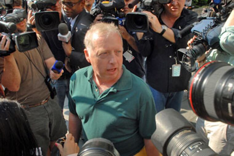 Michael DeVita of Chalfont is mobbed by media as he arrives outside the courthouse in New York City to attend the morning sentencing hearing for Bernie Madoff. (Tom Gralish / Staff Photographer)