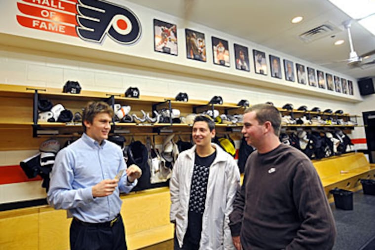 In the Flyers locker room, Flyers rookie James van Reimsdyk (left) chats with his buddies from high school, Paul Passariello (center) and Pat Keenan (right), both are juniors at Villanova and regulars at home games.