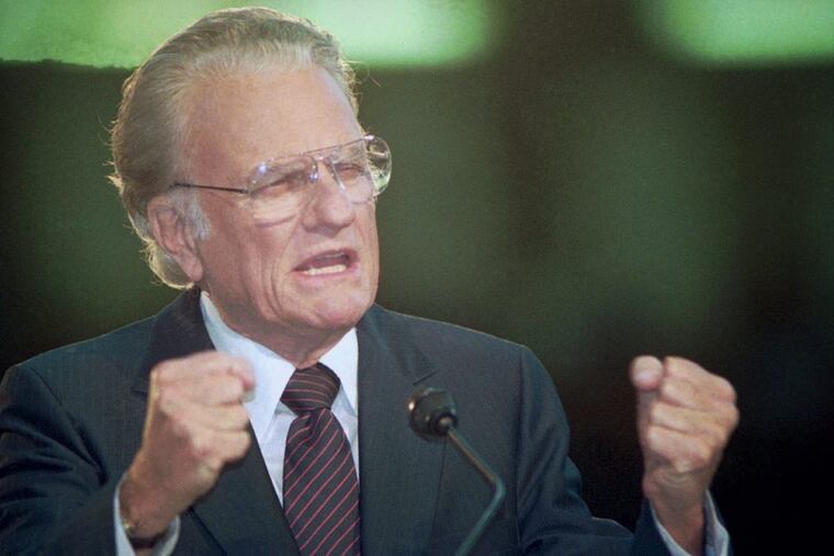 American evangelist Billy Graham gestures to a crowd in Moscow's Olympic arena Oct. 24, 1992. About 30,000 Christians from across the former Soviet Union assembled in Moscow to hear Graham.