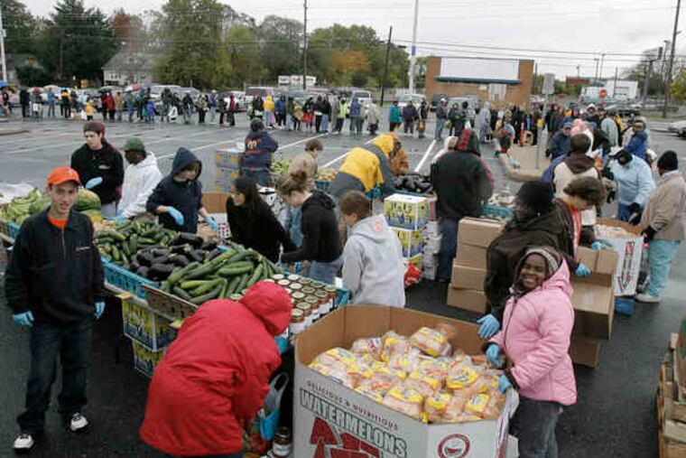 At the Lindenwold PATCO station, people line up to seek produce from the Fresh for All program.
