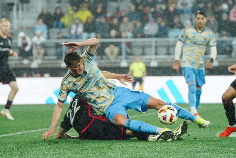 Jack McGlynn (center) duels for the ball with D.C.'s Aaron Herrera during Saturday's game.