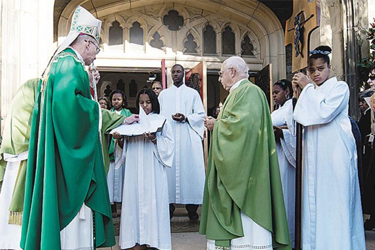 Bishop Timothy Senior blesses Monsignor Wilfred J Pasley as the pastor of both St. Barbara's in Wynefield and St. Rose of Lima in Overbrook. Both Parishes were merged into St. Barbara's.