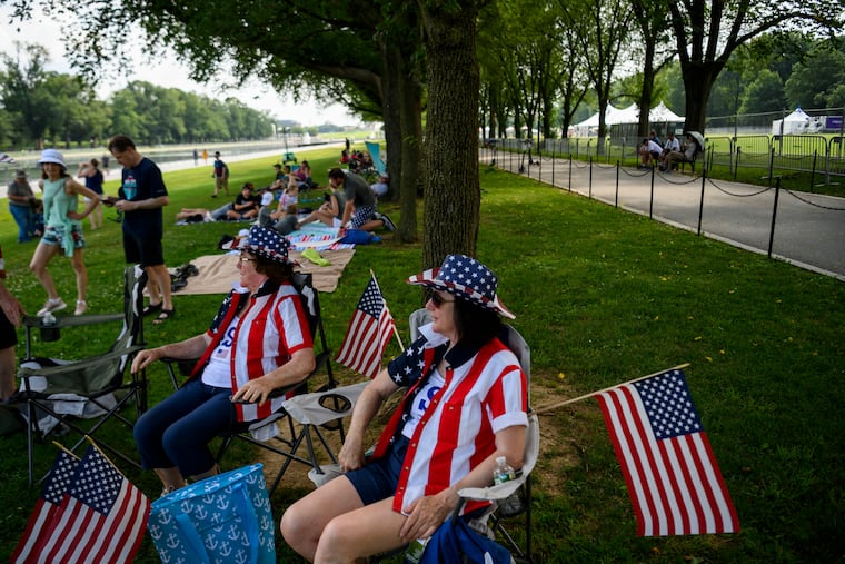 Betty-Ann Lang, right, and her sister Deborah Sheldon, both of Rhode Island, sit and wait for the "Salute to America" event to start on July 4 near the Lincoln Memorial.
