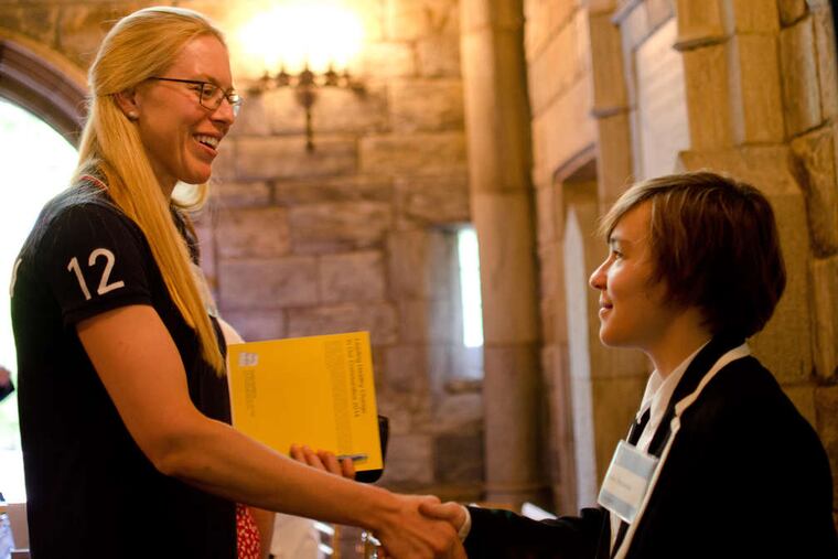 Rower Esther Lofgren (left), who struck Olympic gold at the London Games, and student journalist Julia Olszewski meet and compliment each other on their achievements. More than 225 students participate in the Healthy NewsWorks program.