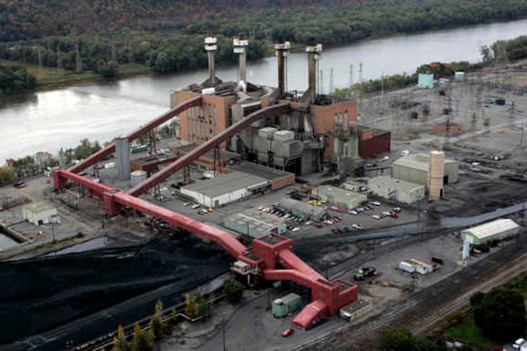 U.S. Rep. Jim Gerlach hosted a talk on cutting carbon emissions. At rear, the coal-fired Sunbury power plant in Shamokin Dam, Pa.
