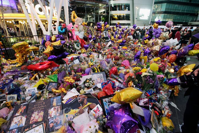 Fans gather at a memorial for the late Kobe Bryant in front of Staples Center in Los Angeles, Sunday, Feb. 2, 2020. Bryant, the 18-time NBA All-Star who won five championships and became one of the greatest basketball players of his generation during a 20-year career with the Lakers, died in a helicopter crash Sunday, Jan. 26.