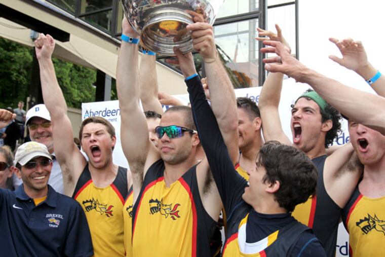 The Drexel University Men's Varsity Heavyweight Eight celebrates as senior captain Kurt Linton (center) raises the Richard O'Brien trophy after they won the finals in the event at the Dad Vail Regatta on May 11, 2013. (Charles Fox/Staff Photographer)