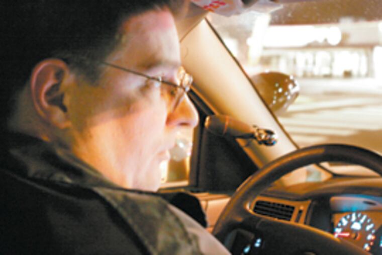 Officer Henry Schoch patrols the 35th Police District in Northwest Philadelphia. Police hope to tackle street-corner crime before the guns fire. (John Costello / Inquirer)